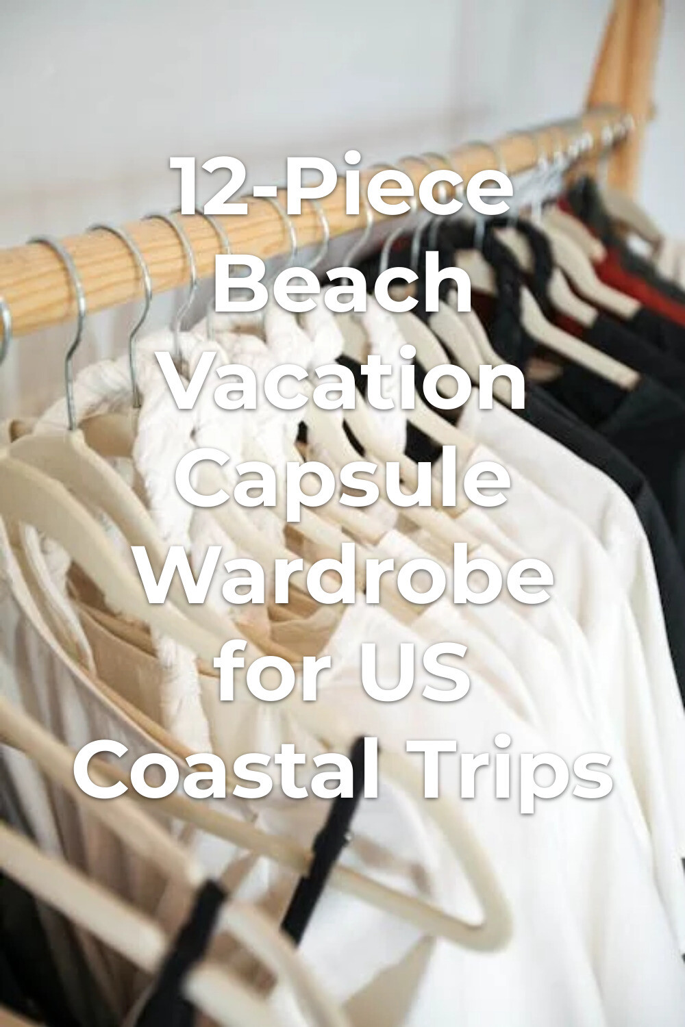 Beach Vacation Capsule Wardrobe Clothing Rack Beach vacation capsule wardrobe with light and dark clothes on white hangers on a wooden rack for minimalist packing