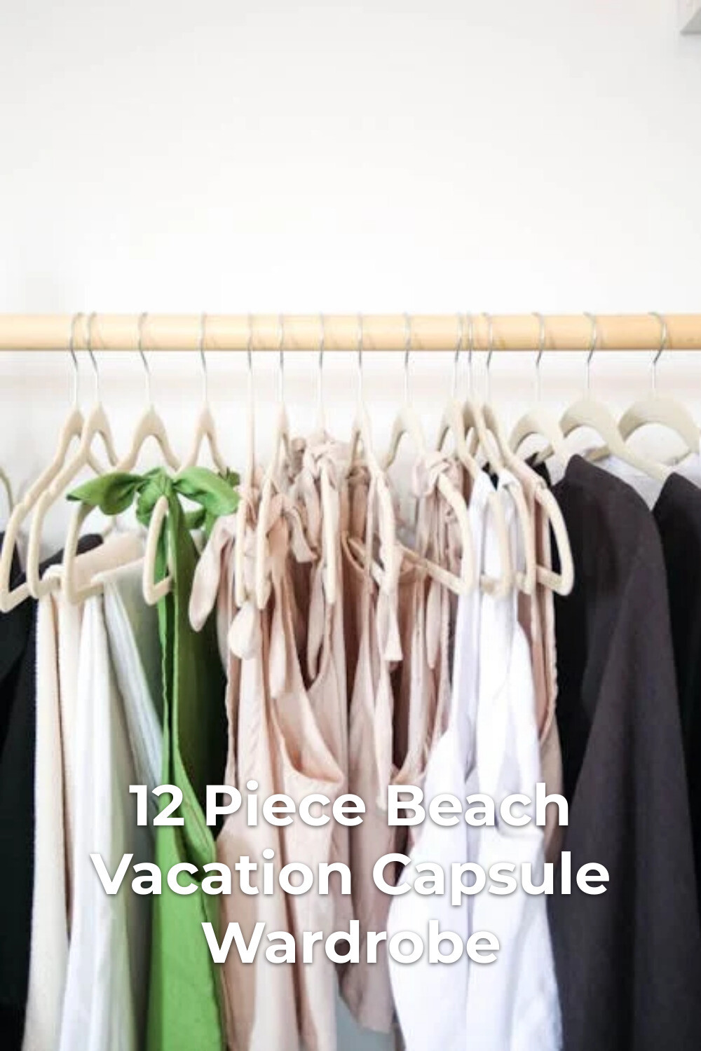 Beach Vacation Capsule Wardrobe Hanging Clothes Colorful clothes on wooden hangers for a beach vacation capsule wardrobe against a white wall