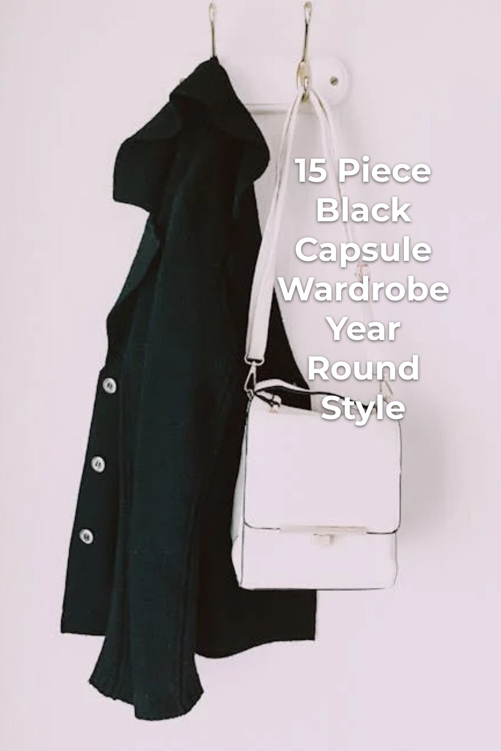 Black Capsule Wardrobe Coat and White Bag Black capsule wardrobe essentials: black coat with white shoulder bag on white wall hooks