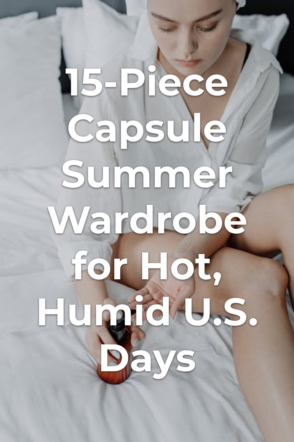 Capsule summer wardrobe essentials: person in white shirt on bed holding a pump bottle over an open hand