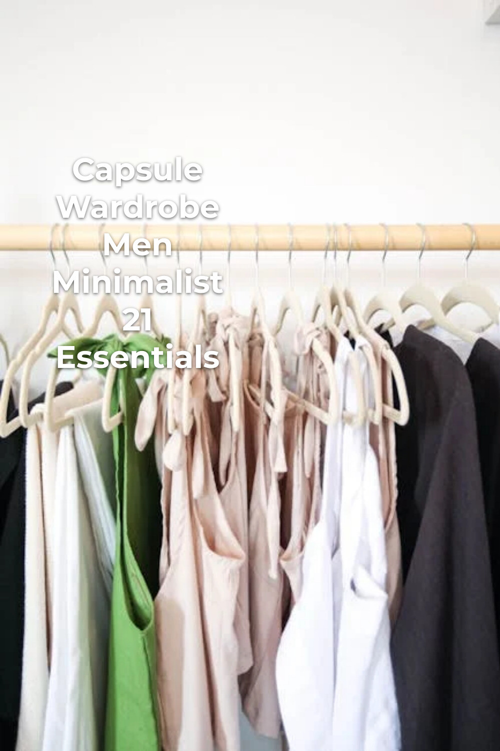 Minimalist Capsule Wardrobe for Men Capsule wardrobe men minimalist with neutral clothes on wooden hangers against a white wall
