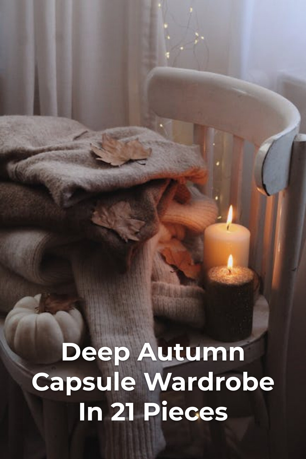 Deep Autumn Capsule Wardrobe Cozy Flatlay Deep autumn capsule wardrobe essentials with folded sweaters, dry leaves, candles, and a small pumpkin by a window