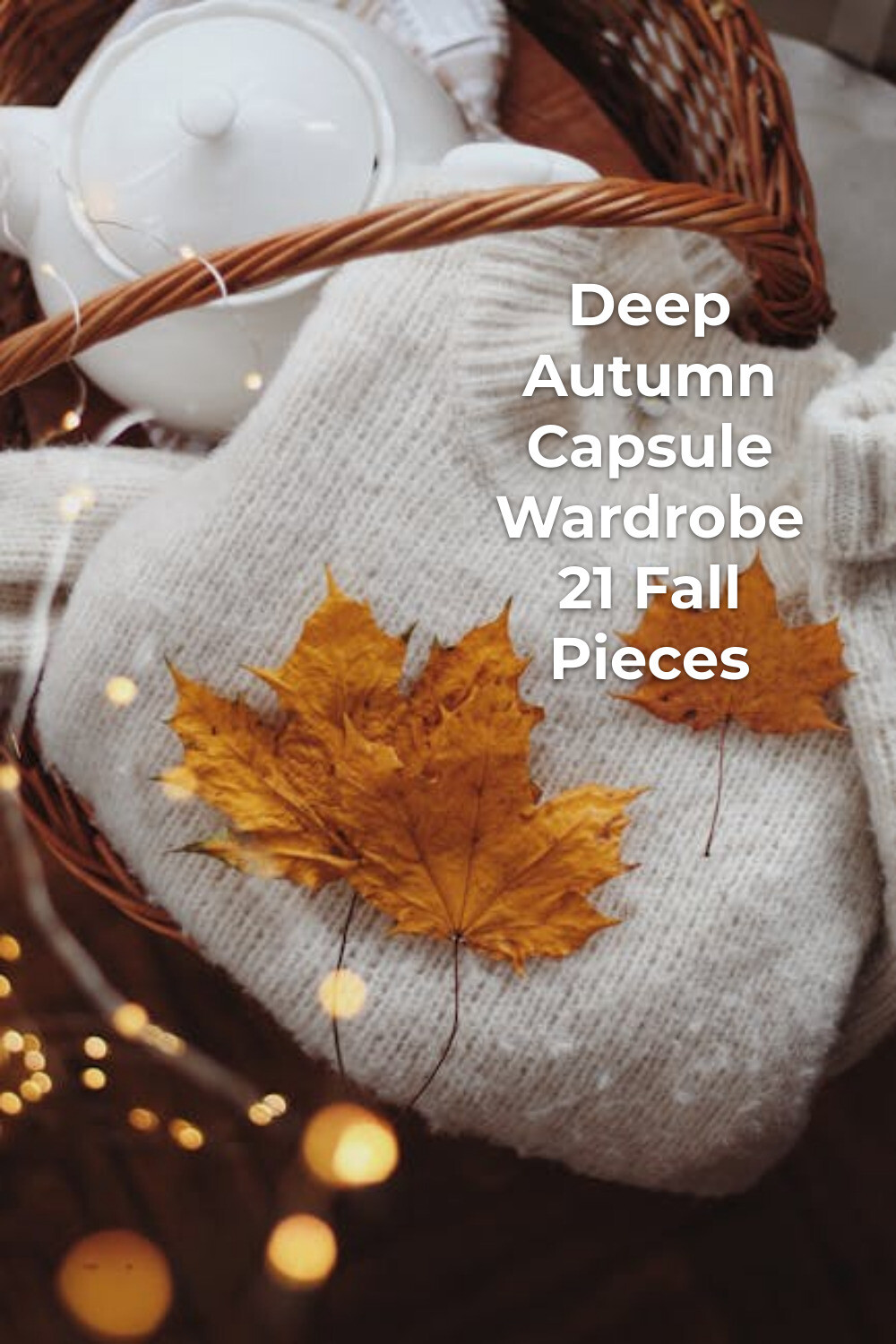 Deep Autumn Capsule Wardrobe Cozy Knit Flat Lay Deep autumn capsule wardrobe essentials with white knit sweater, dried leaves, wicker basket and white teapot