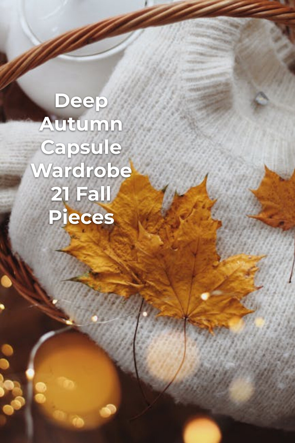 Deep Autumn Capsule Wardrobe Cozy Flat Lay Deep autumn capsule wardrobe flat lay with yellow leaves on white knit sweater by a mug and candle