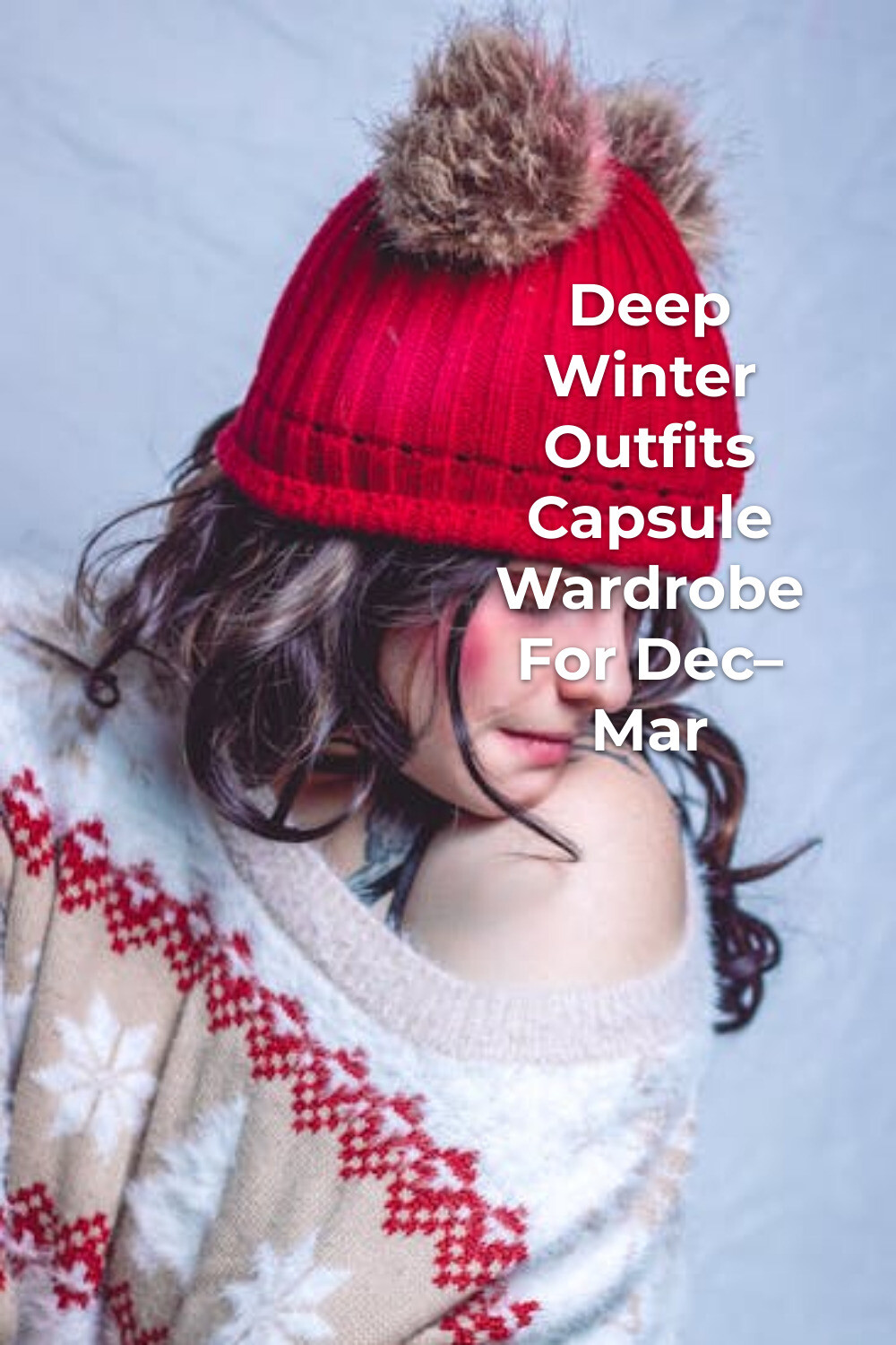 Deep winter outfits capsule wardrobe look: woman in red knit hat with fur pom poms and patterned off-shoulder sweater