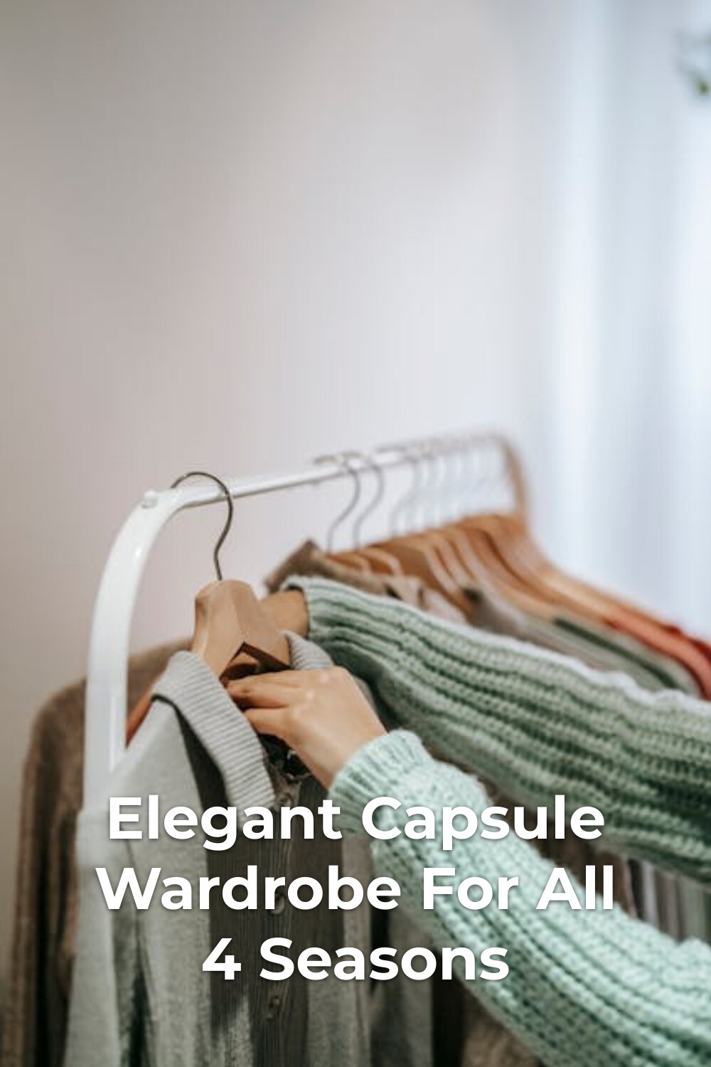 Elegant Capsule Wardrobe Outfit Selection Elegant capsule wardrobe selection with hands in green sweater holding a gray shirt on a hanger
