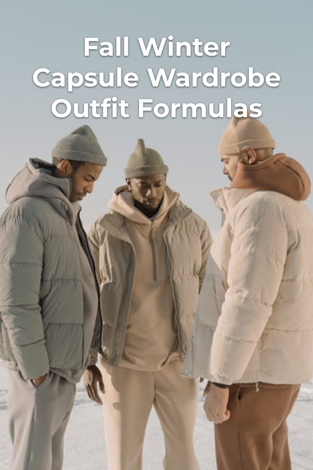 Fall winter capsule wardrobe: three men in minimalist winter jackets and knit hats standing on snow under a clear sky