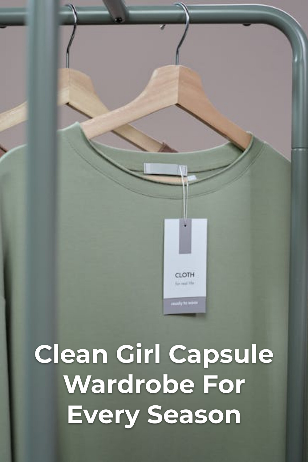 Green shirt with hanging tag on wooden hanger for a clean girl capsule wardrobe