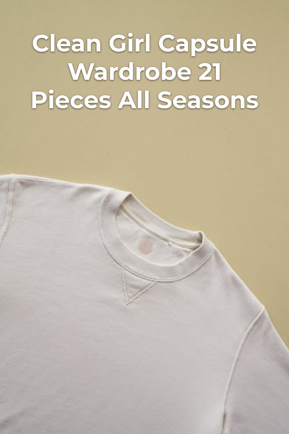 Light gray crewneck sweatshirt on beige surface for a clean girl capsule wardrobe, minimalist staple