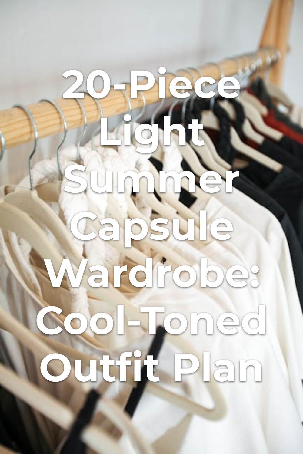 White and black outfits on hangers for a light summer capsule wardrobe on a wooden rack