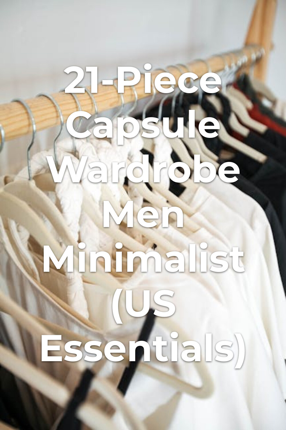 Minimalist men's capsule wardrobe on clothing rack Capsule wardrobe men minimalist with white and black clothes on hangers on a wooden clothing rack