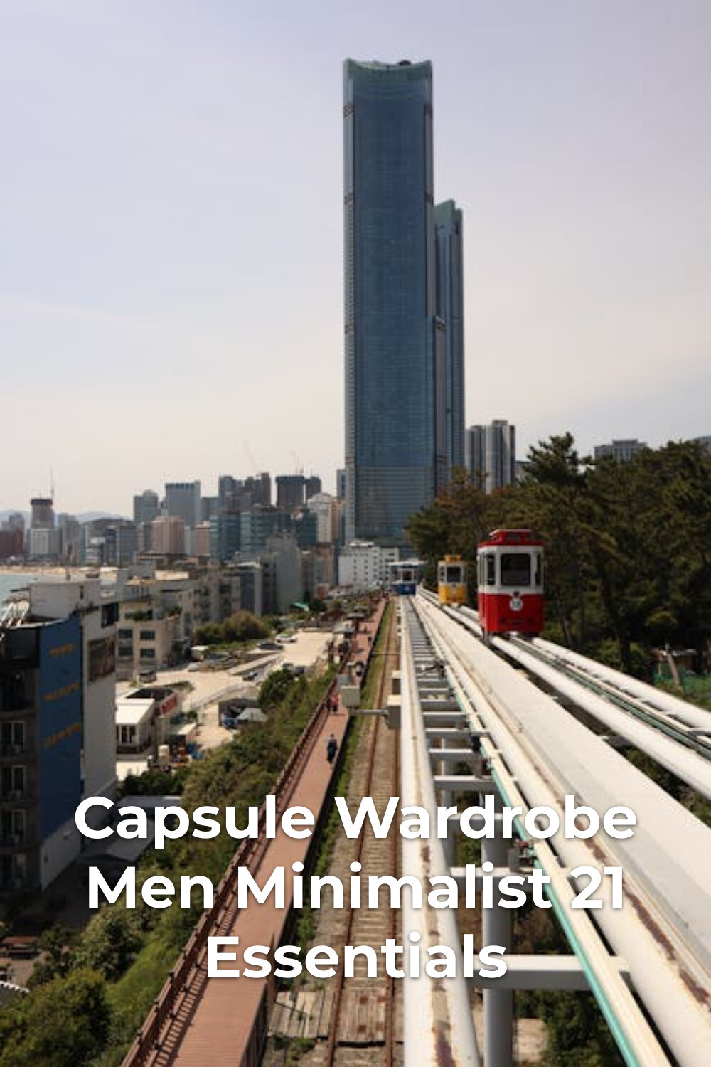 Red and Yellow Trains by City Skyline Red and yellow trains on elevated tracks by city skyline, capsule wardrobe men minimalist inspiration